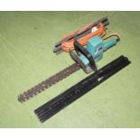 A Black and Decker electric hedge trimmer