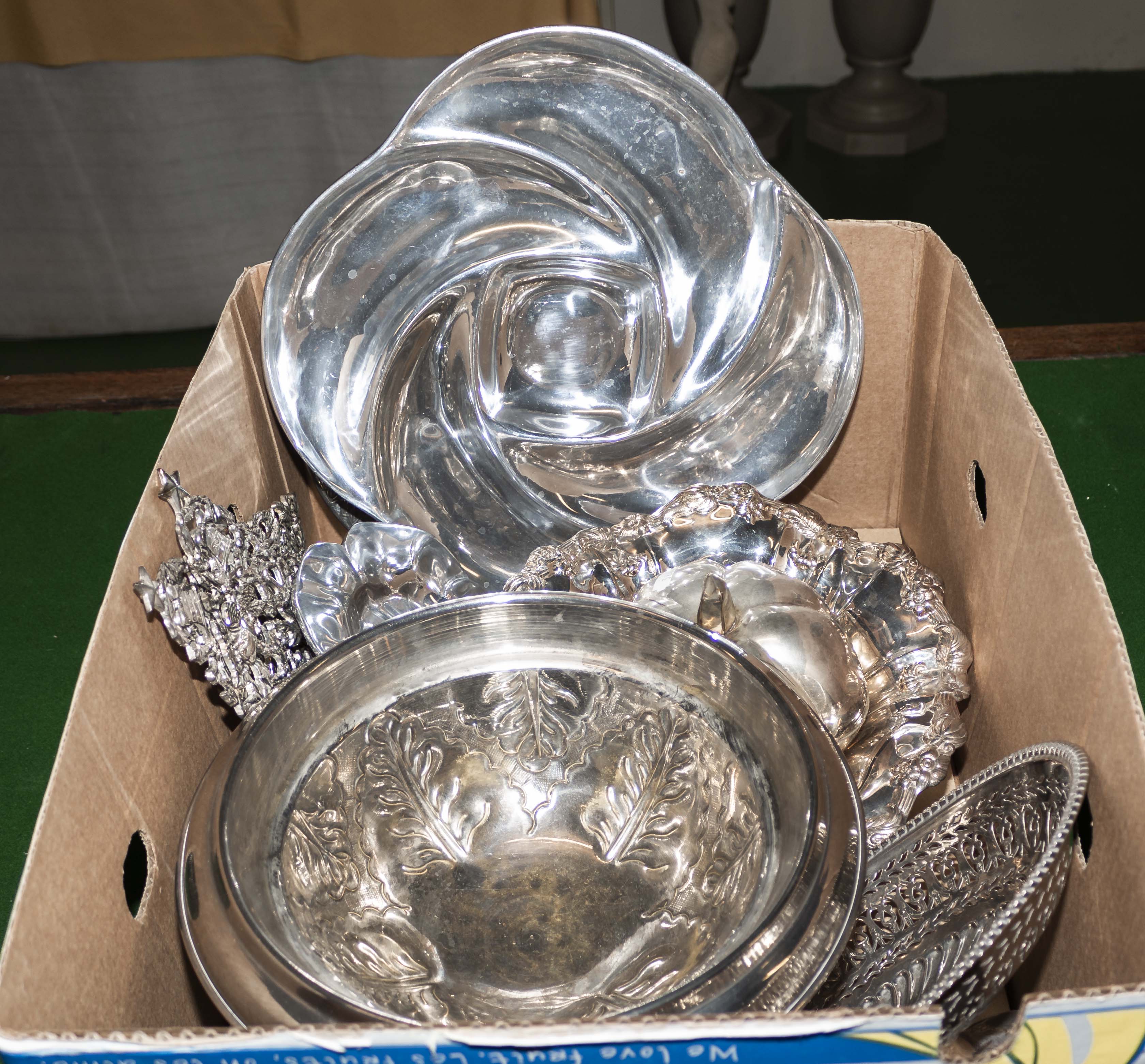 A box containing silver plated ware