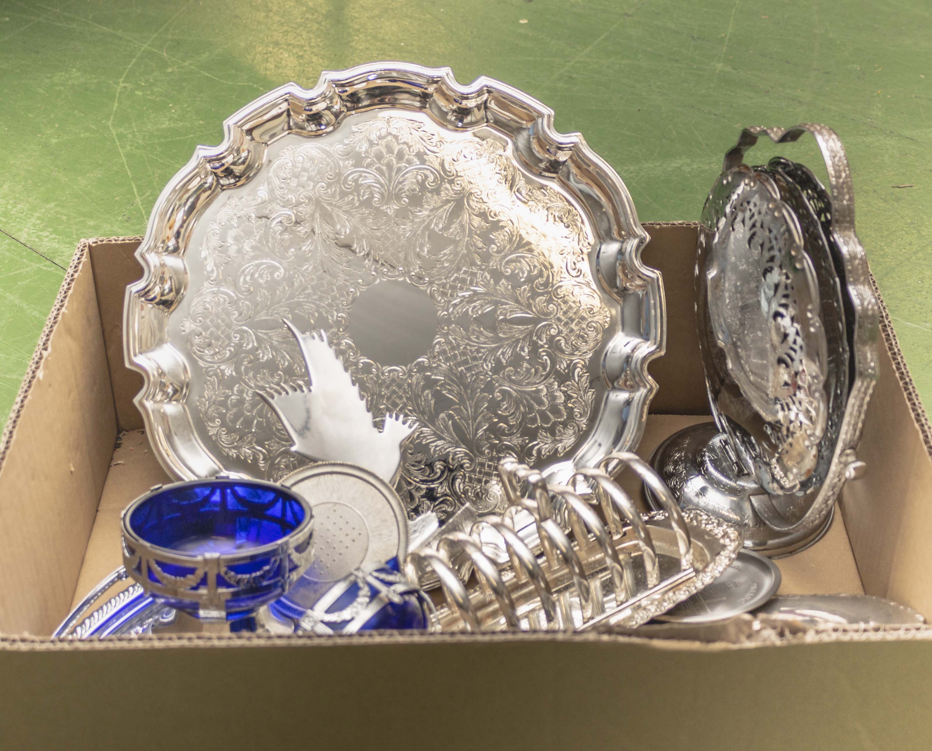 A box containing silver plated items