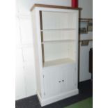 A painted bookcase on cupboards