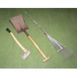 An axe, shovel and garden rake