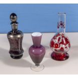 A glass decanter and two vases