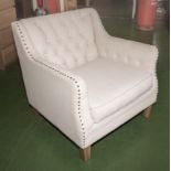 An upholstered button backed armchair