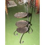 A wrought iron and copper cake stand
