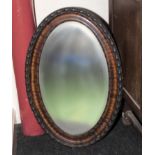 An oval wall mirror