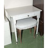 A small white painted desk and a stool