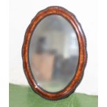 An oval framed mirror