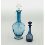 A blue glass decanter and a small scent bottle