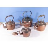 Four copper kettles and a copper mould