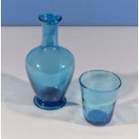 A blue glass carafe and tumbler