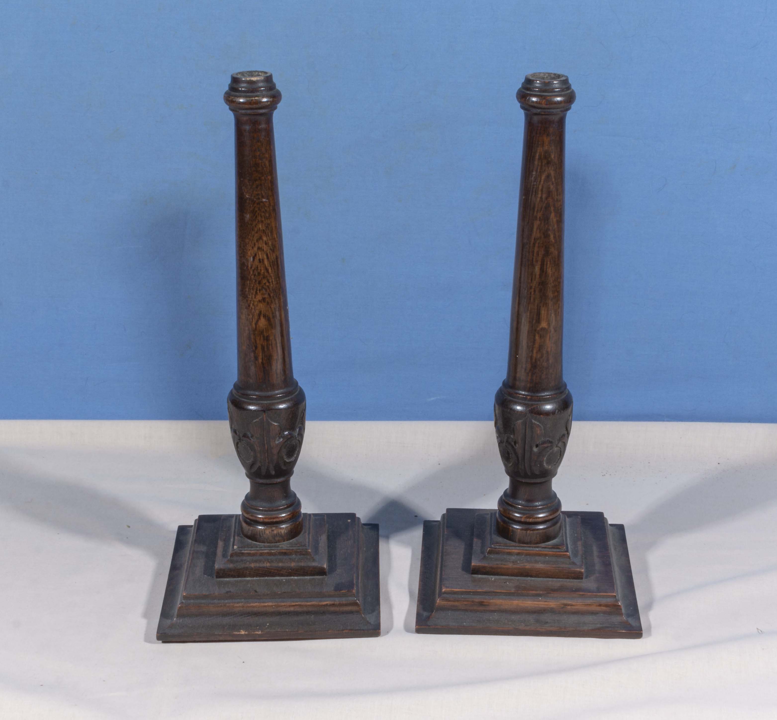 A pair of wood candlesticks