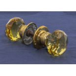 A pair of Victorian amber glass door handles