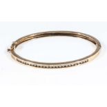 A 9ct gold bangle set with 1ct of diamonds