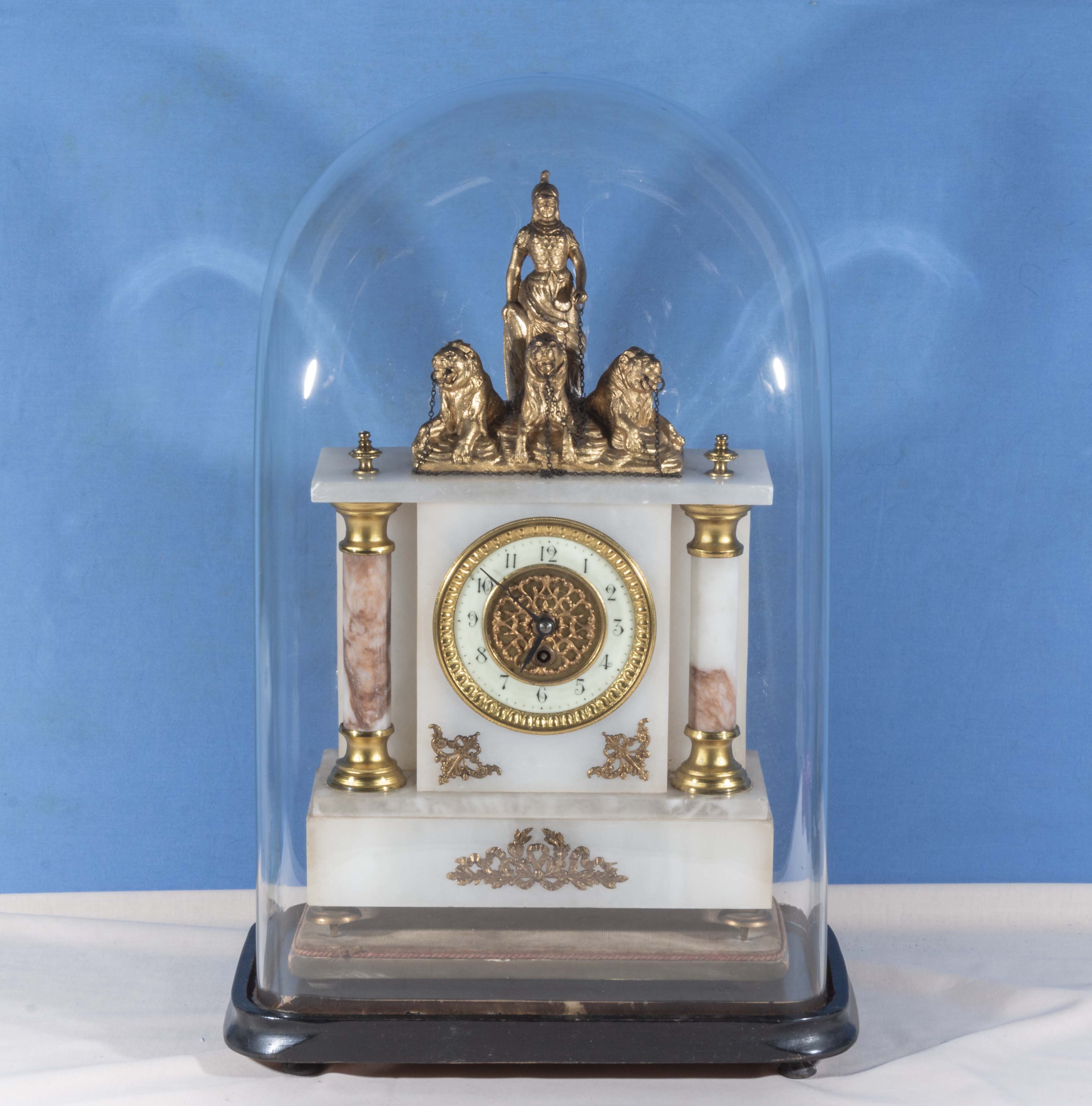 A white marble with gilt metal mounts clock with glass dome