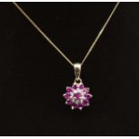 A 9ct gold ruby and diamond cluster pendant and chain