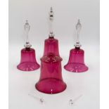 Four ruby glass bells, 33cm tall