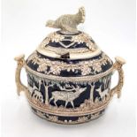 A large continental heavily decorated pottery tureen and lid