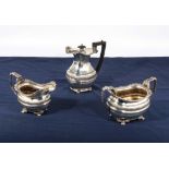 A three piece part silver tea service, total weight 837gms, Marks for Chester 1909, George &