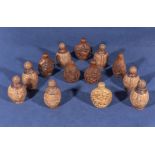 A collection of 20th century Chinese walnut shell and wood carved snuff bottles