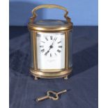 An oval brass carriage clock in case