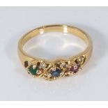 An antique gold coloured metal ring set with semi precious stones