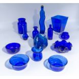 A selection of blue glass bowls, vases and bottles
