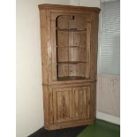 A Victorian pine barrel back corner cabinet with open top shelving and double door base, 210cm