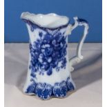 A flow blue pottery jug, 18cm tall