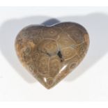 A piece of polished coral in the shape of a heart, 8cm x 7cm