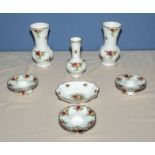 A pair of Royal Albert Country Roses vases, four candle holders and three other pieces