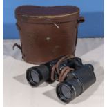 A pair of binoculars in a leather carrying case