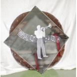 An Art Deco pink and clear wall mirror with trumpet player, 76cm square