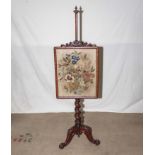 A Victorian walnut pole screen with tripod base