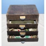 A four drawer cabinet containing Malloy fly tins, flies , weights, lures and vice, cabinet