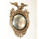 An Edwardian Regency style carved wood and gesso wall mirror, 92cm tall