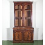 A Victorian mahogany bookcase two glass doors above aa two door base.