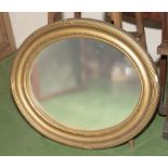 A gilt framed oval wall mirror, 61cm x 53cm