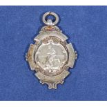 Football interest, a silver fob watch medallion depicting a footballer in play, silver mark for