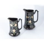 Two black pottery jugs, 20cm and 16cm