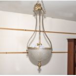 A brass hanging lamp with wide cut glass bowl and shaped brass frame with torch shaped finials,