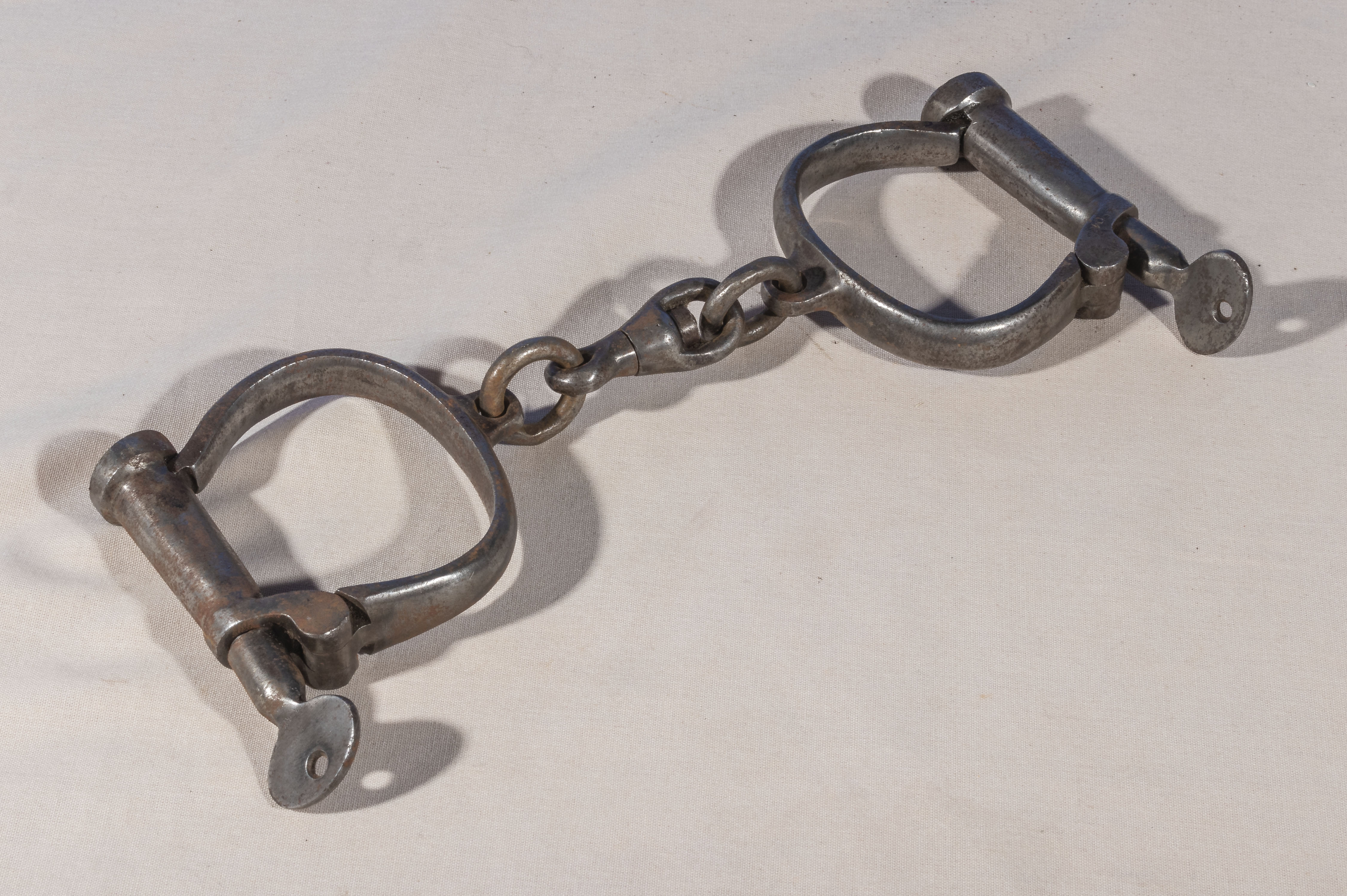 A pair of vintage military handcuffs stamped 1953 RCS, with keys