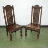 A pair of Victorian oak hall chairs with dragon carved panels.1m tall