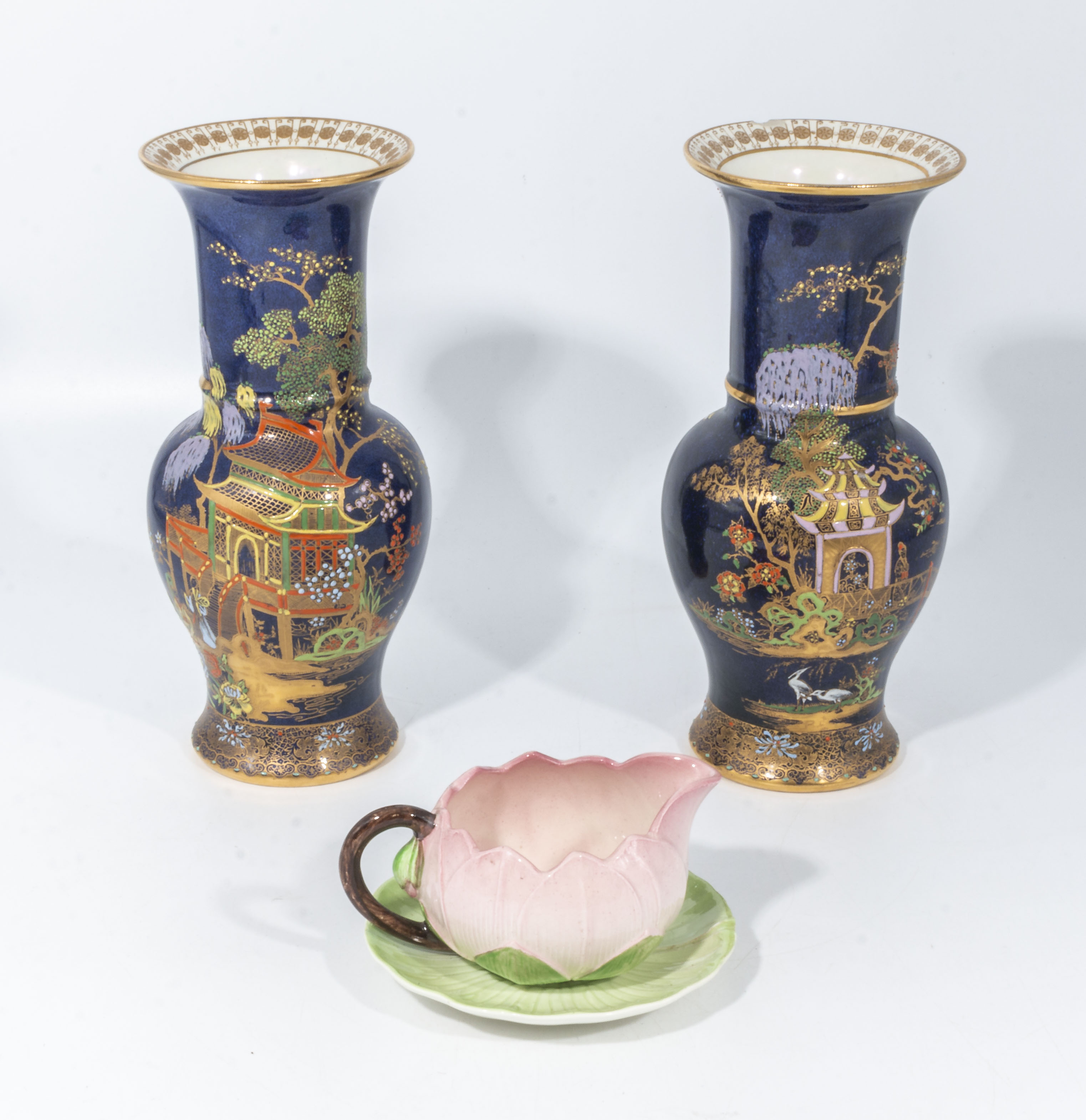 A pair of Carlton Ware vases and a cup and saucer, vases 21.5cm tall