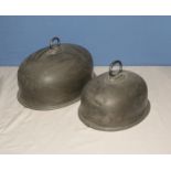 Two pewter meat covers, 40cm and 30cm