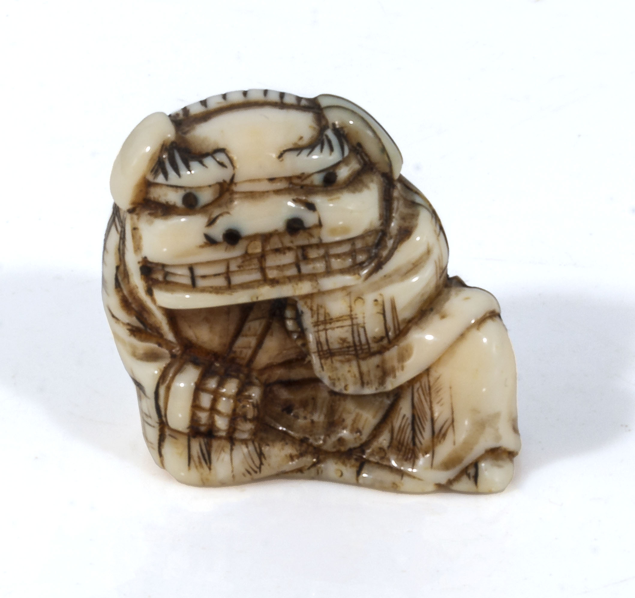 An antique Japanese ivory netsuke meiji period, depicting a boy dressed in a dragon outfit, with