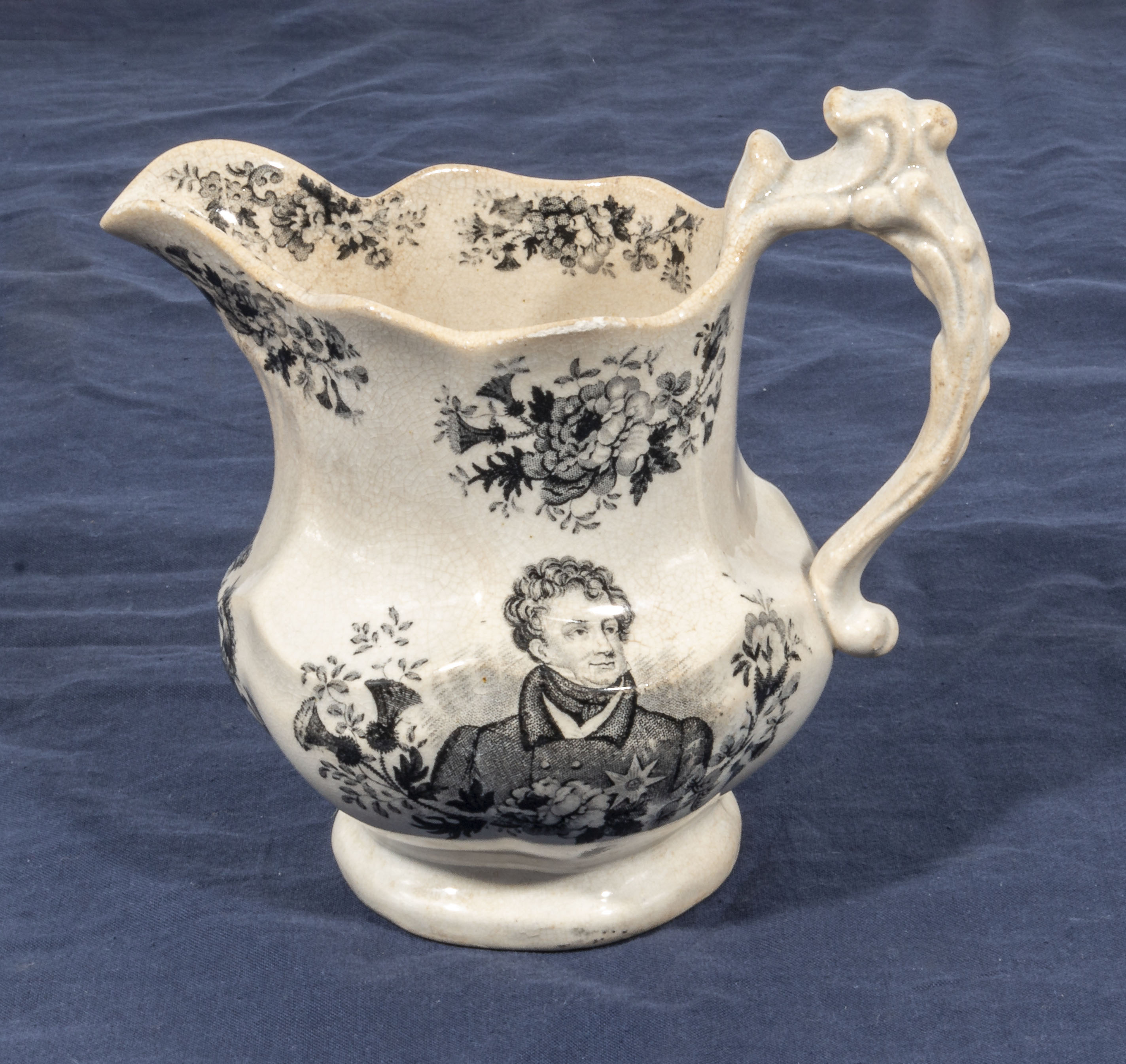 An antique black transfer printed- ware Staffordshire George 1V pottery jug. To the memory of his