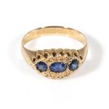 An 18ct gold ring set with three sapphires and diamonds, 2.5gms