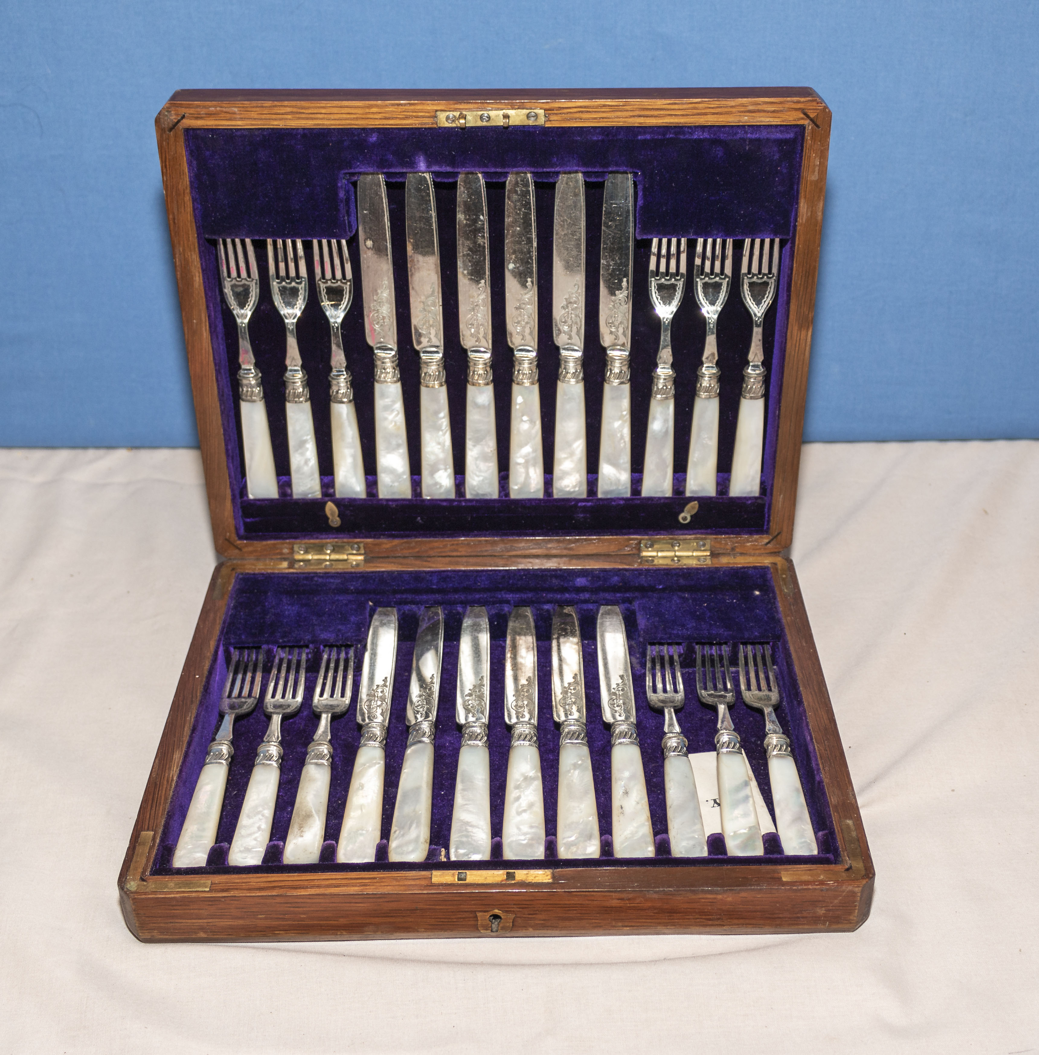 A twelve piece setting canteen of cutlery with mother of pearl handles