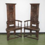 A pair of early Victorian period style oak high back chairs, half moon shaped seats with carved