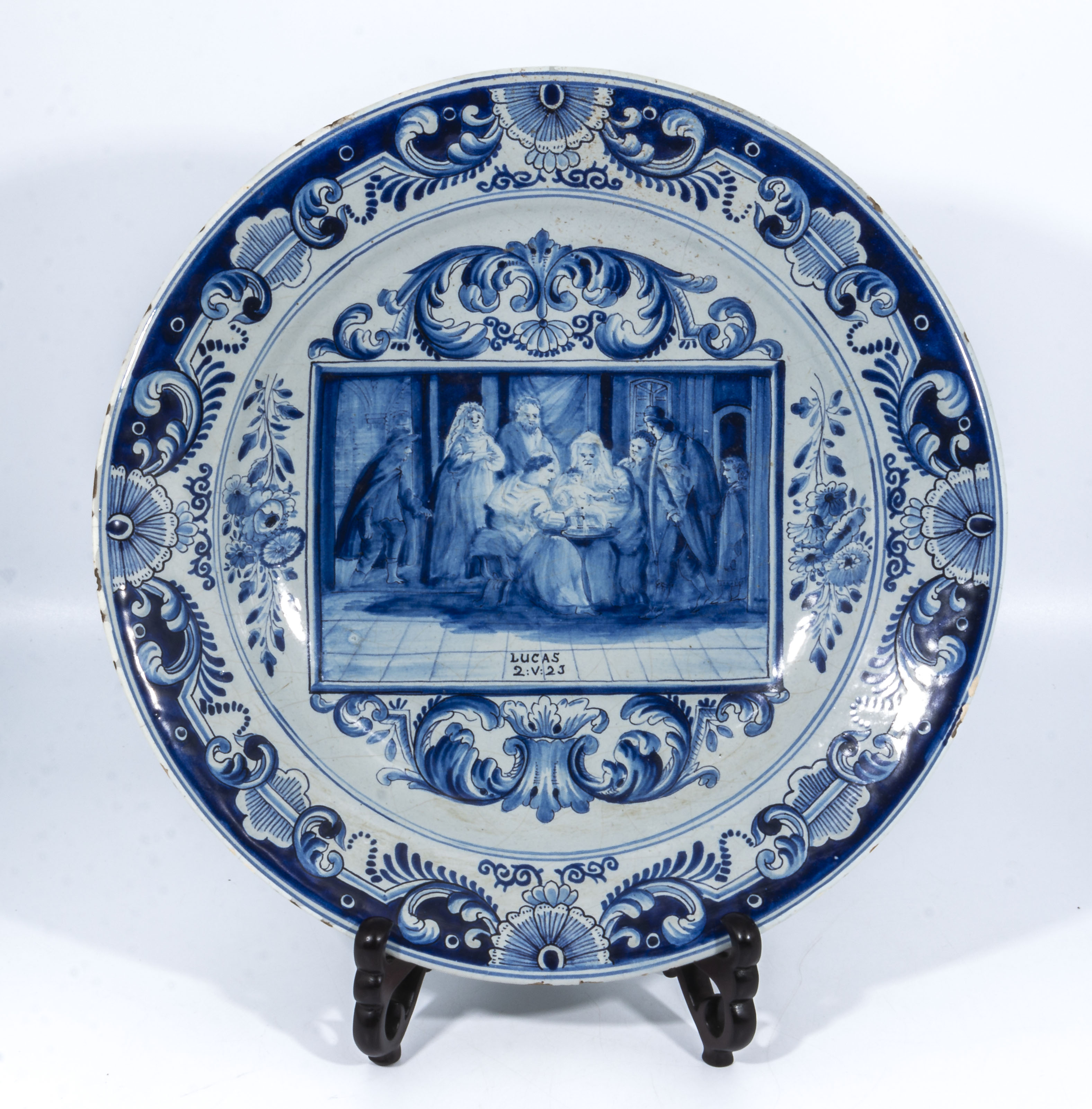 Antique delftware pottery charger with unusual painted decoration, the centre panel depicting a